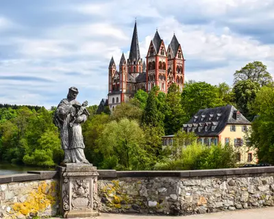 The Catholic Cathedral of Limburg at the river Lahn (German: Dom zu Limburg), Germany, viewed from the old Lahn bridge with a statue of Saint John of Nepomuk.