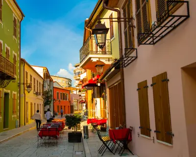 VLORA/VLORE, ALBANIA: Historical multi-colored buildings on the street in the city center. Shops, cafes and restaurants for tourists.