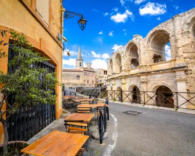 Arles Amphitheatre and colorful street architecture view, South of France