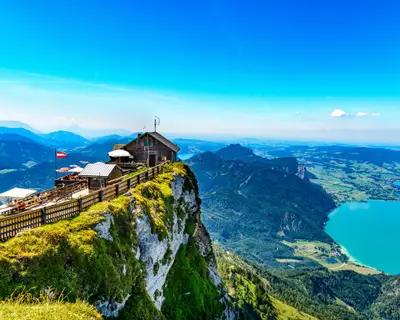 Amazing panorama view from Schafberg by Sankt Wolfgang im Salzkammergut on Haus house Schafbergspitze, lake Mondsee (moonlake, moon), Attersee. Blue sky, alps mountains. Upper Austria, Salzburg