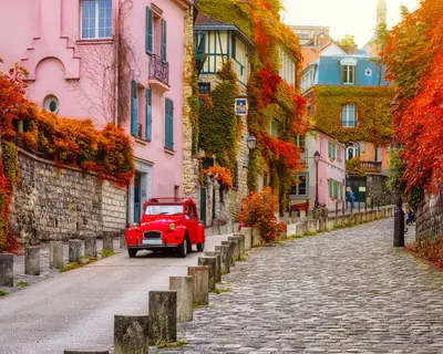 Cozy street in quarter Montmartre in Paris, France. Architecture and landmarks of Paris. Postcard of Paris