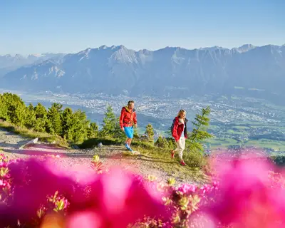 Austria, Tyrol, Couple hiking the Zirbenweg at the Patscherkofel