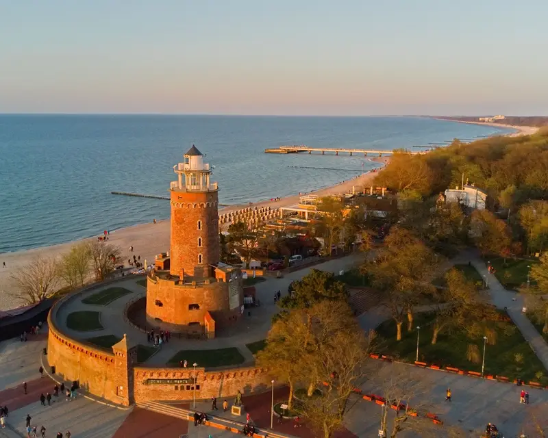 Harbour, lighthouse and pier in Kolobrzeg, Poland. Golden hour, january 2023.